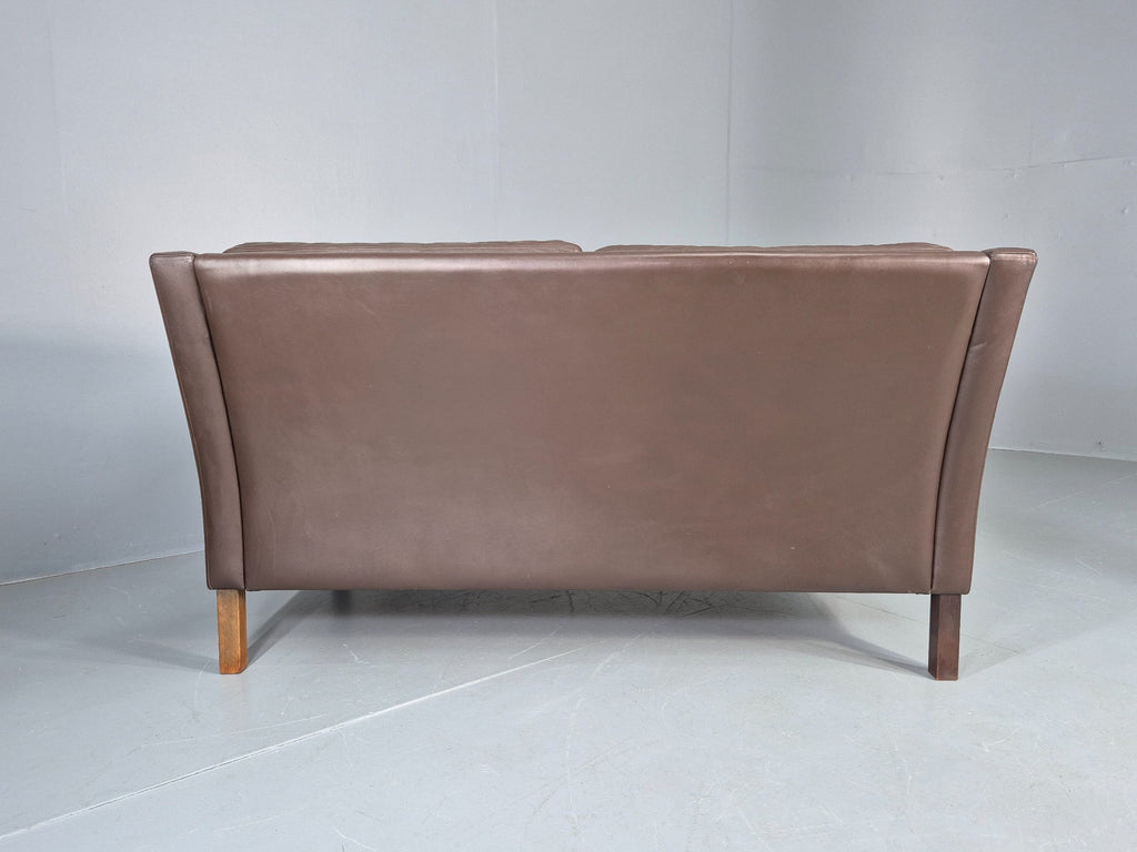 Brown leather sofa tapered leg detail