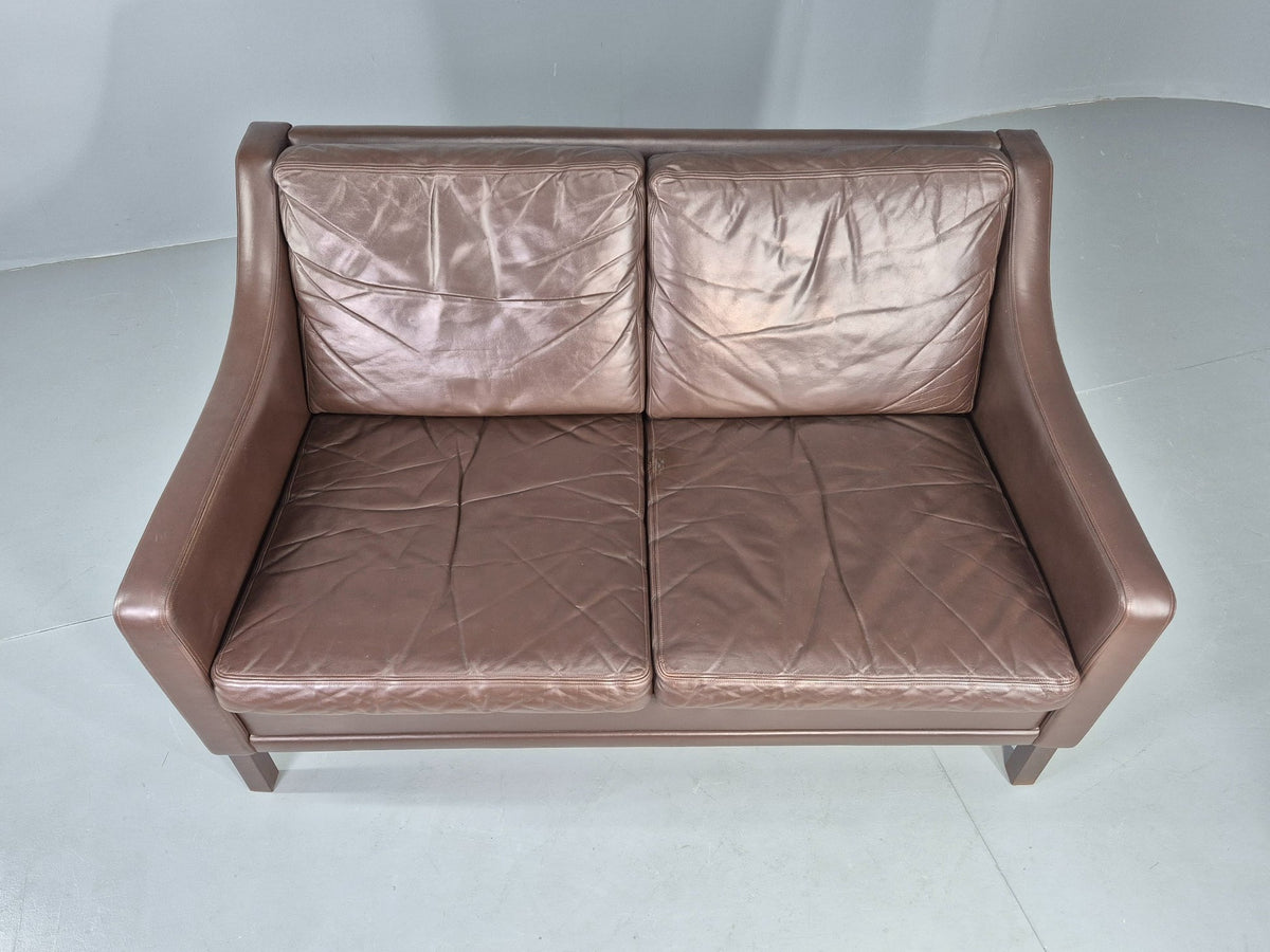 Brown leather sofa beech frame leg detail