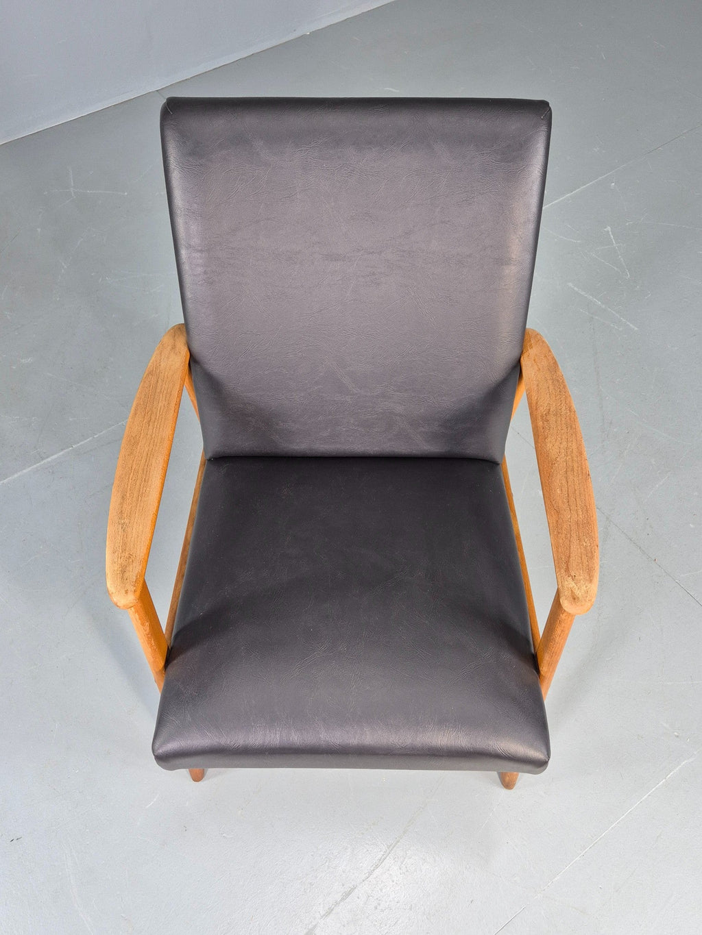 Teak lounge chair black vinyl upholstery close-up