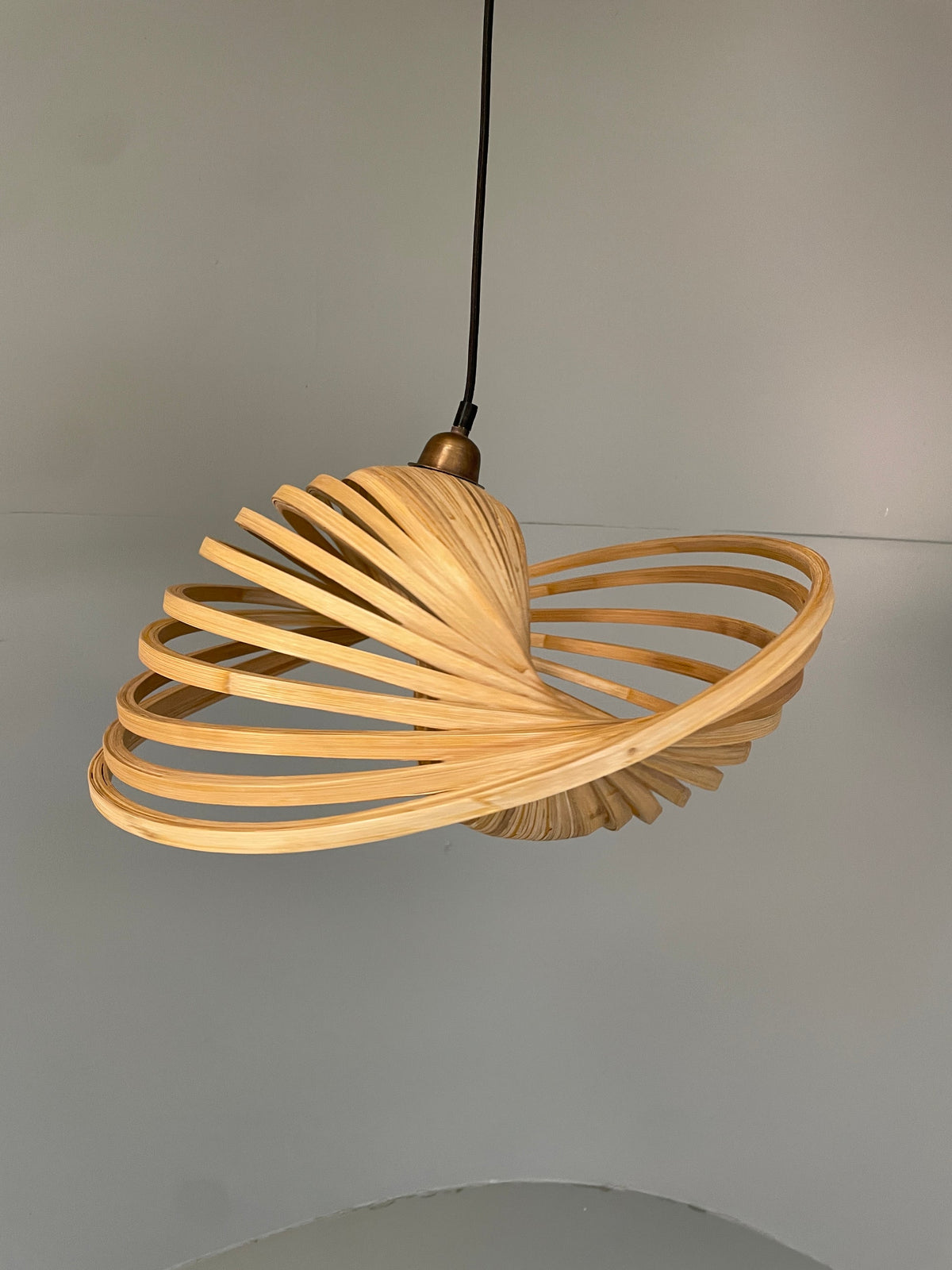 Freeform bamboo pendant lamp side view natural weave
