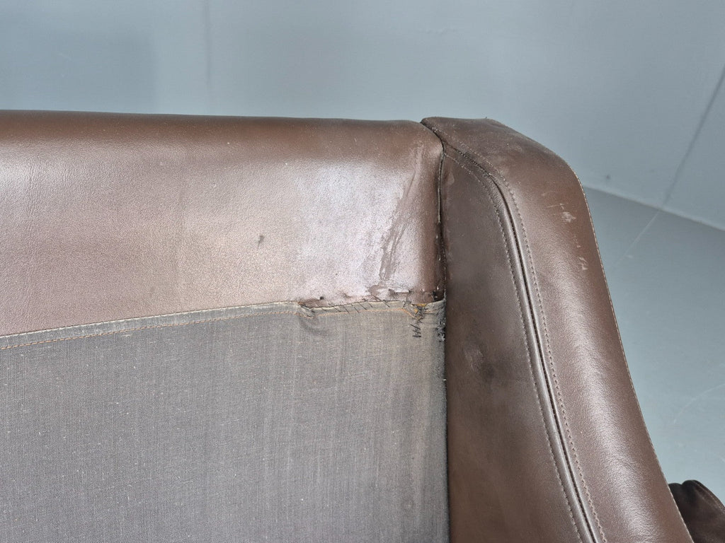 Brown leather sofa arm wear detail