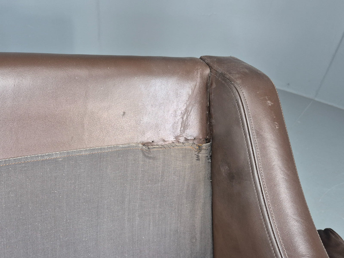 Brown leather sofa arm wear detail