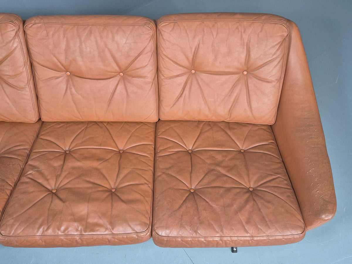 Tan leather sofa arm contact area patina detail